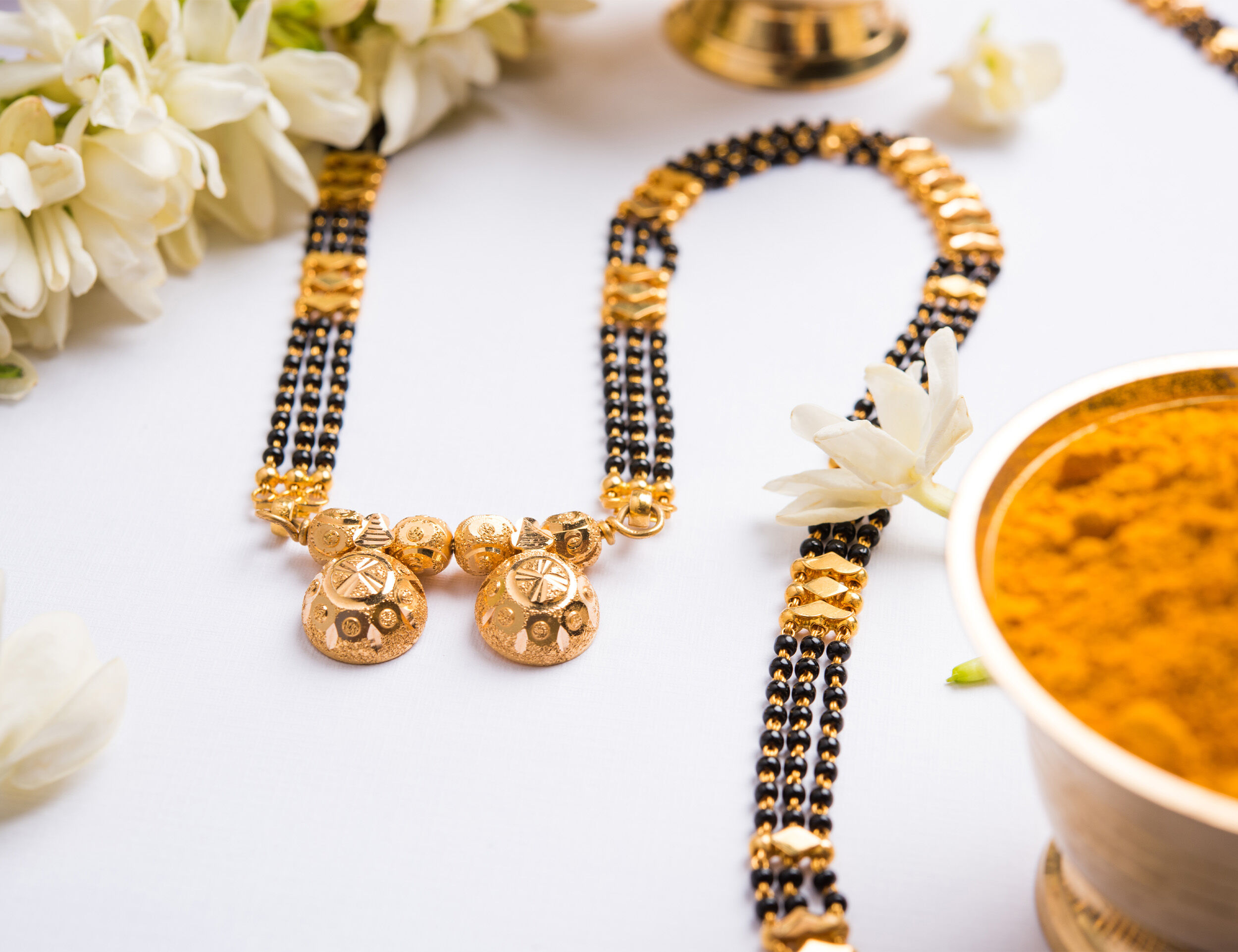 Groom tying the mangalsutra around the bride's neck